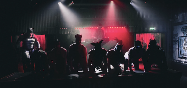 Crowd gathered before the stage as red light cuts through the fog at a past Baltic Battle